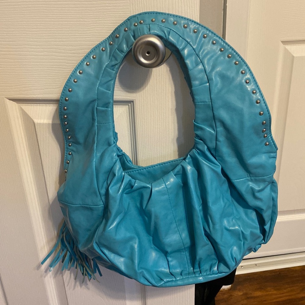 Aldo’s Teal colored hand bag